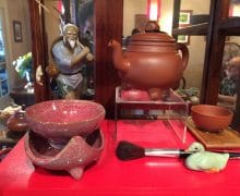 A Fisherman piece beside a yixing pot with a red filter