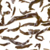 Rougui wet tea leaves floating in clear water.
