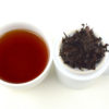 Cupped infusion of Home Store shu puer tea and strained leaves.