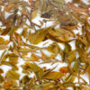 Daxueshan (Snow Mountain) sheng puer tea leaves floating in clear water.
