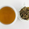Daxueshan (Snow Mountain) sheng puer tea infusion and strained leaves.
