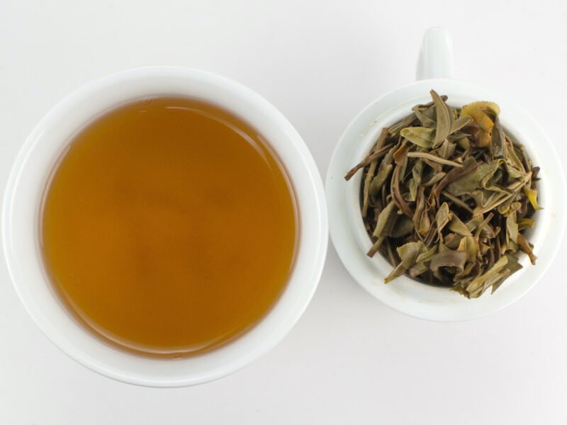Daxueshan (Snow Mountain) sheng puer tea infusion and strained leaves.