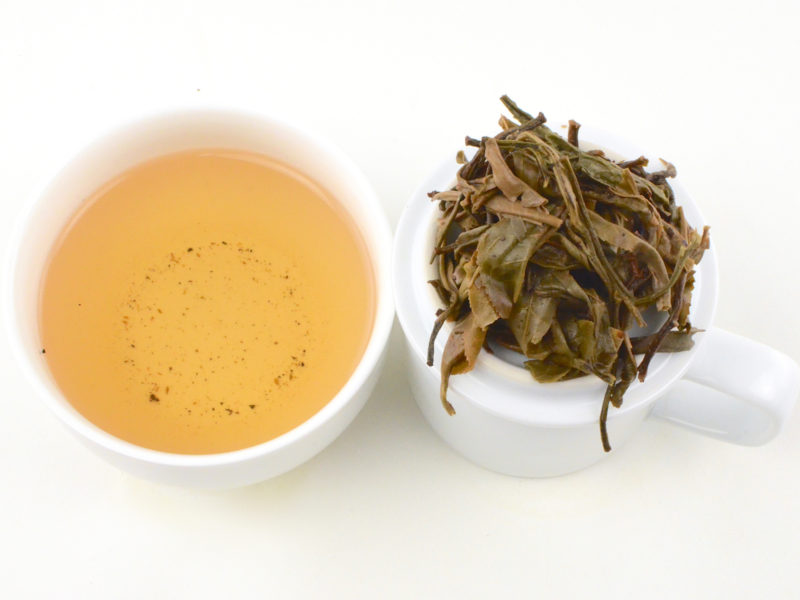 Daxueshan (Snow Mountain) sheng puer tea infusion and strained leaves.