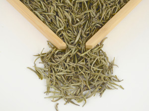 The pale, long, straight needle-shaped leaves of Jun Shan Yin Zhen yellow tea.