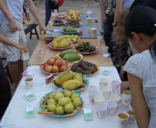A long table covered in platters of fresh fruit.