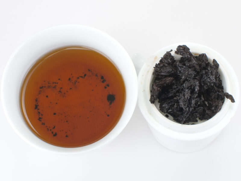 Cupped infusion of Tai Lian Fangzhuan (Tai Lian Brick) 2004 shu puer tea and strained leaves.