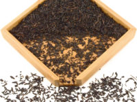 Lapsang Souchong black tea dry leaves in a wooden display box.