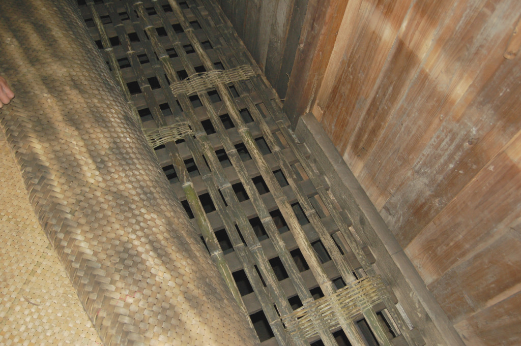 Smoke-stained bamboo slats in the floor of the second level of the tea factory allow smoke to rise up to the tea.