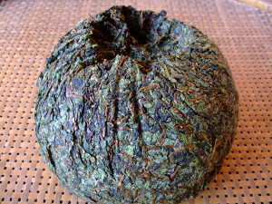 The unwrapped ball of compacted Anxi wulong tea.