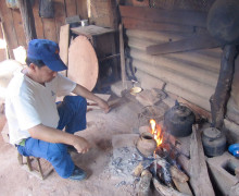 Tea master Wang Xi Qun boiling roasted tea over a fire.