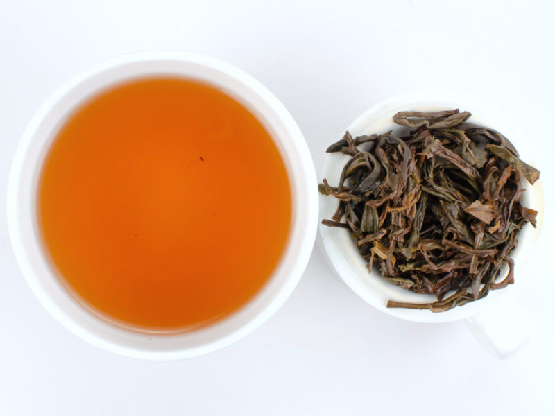 Cupped infusion of Huang Zhi Xiang and strained tea leaves.