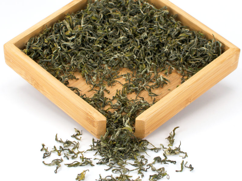 Mengding Ganlu (Sweet Dew) green tea dry leaves in a wooden display box.