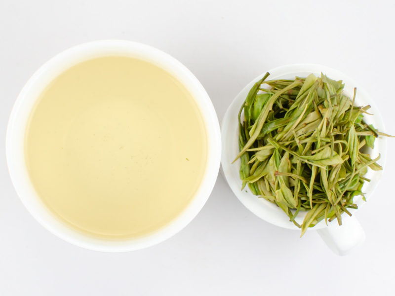 Cupped infusion of Yu Qian Anji Baicha (Spring Rain Harvest Anji) green tea and strained leaves.