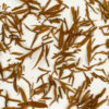 Jinya (Yunnan Golden Buds) wet tea leaves floating in clear water.