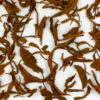 Jin Konque (Golden Peacock) wet tea leaves floating in clear water.