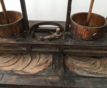 an image of an old wooden kneading machine for creating the teas twisted shape