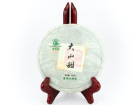 Da Shan Tian (Sweet Mountain) sheng puer cake in paper wrapper.