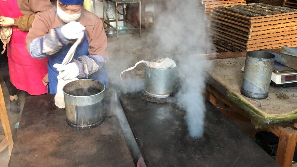Puer tea being prepared for compression with steam
