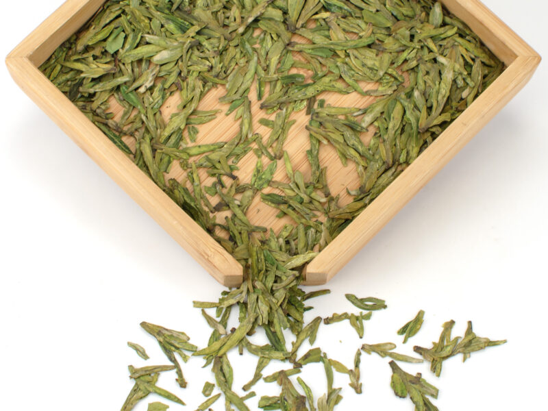 Dry Da Fo Longjing (Big Buddha Dragon Well) green tea leaves.