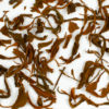 Laoshu Dianhong (Old Tree Yunnan) wet tea leaves floating in clear water.