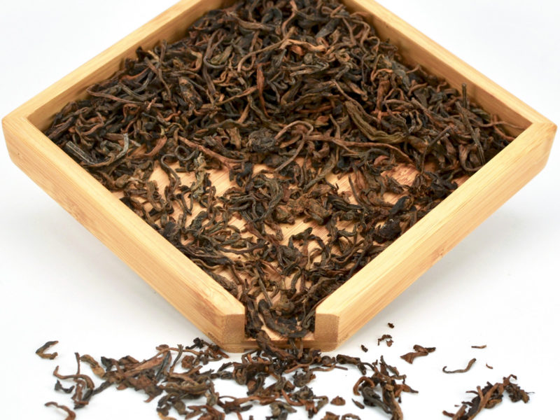 Zi Ye Shu (Purple Leaf Shu Puer) tea dry leaves in a wooden display box.