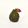 A closed, dry ball of rose jasmine blooming display tea.