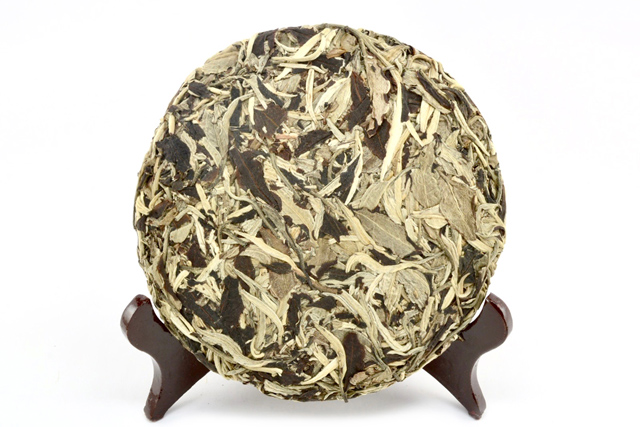 A compressed round cake of white moonlight tea.