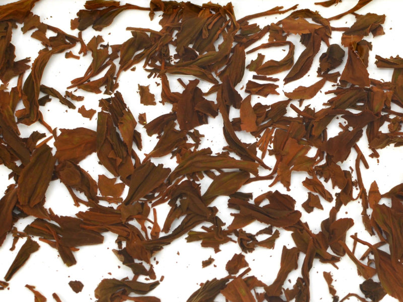 Zui Chun Fang (Drunken Peach) wet tea leaves floating in clear water.