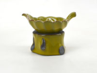 Yellow leaf ceramic tea strainer, side view