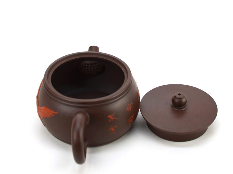 Above view of Eagle Drum Shape yixing clay pot with the lid open to show the built-in strainer bulb behind the spout.