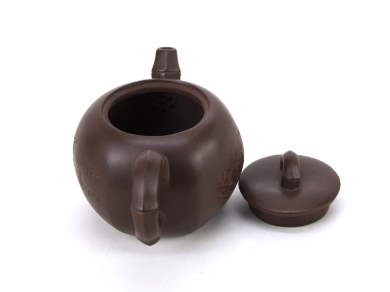 Above view of hexagonal bamboo zi ni yixing clay pot with the lid open to show the built-in strainer behind the spout.