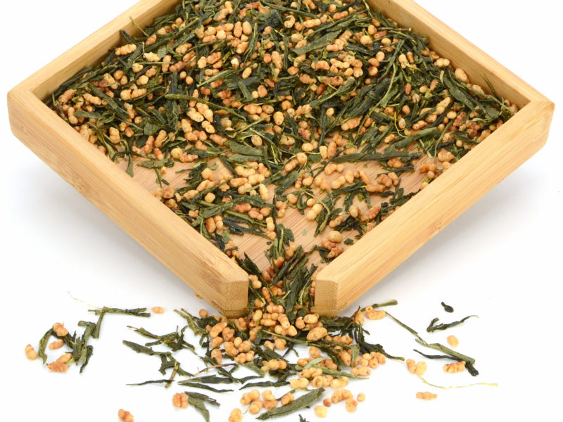 Xuanmicha (Genmaicha) green tea dry leaves and rice grains in a wooden display box.