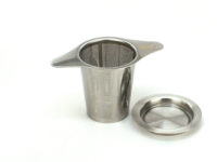 Stainless steel strainer with matching small saucer next to it.