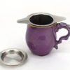Stainless steel strainer being used as an infuser in a large cup.