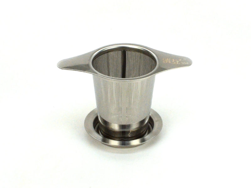 Stainless steel strainer resting in saucer.