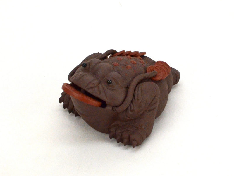 Angle view of golden toad yixing clay tea pet.