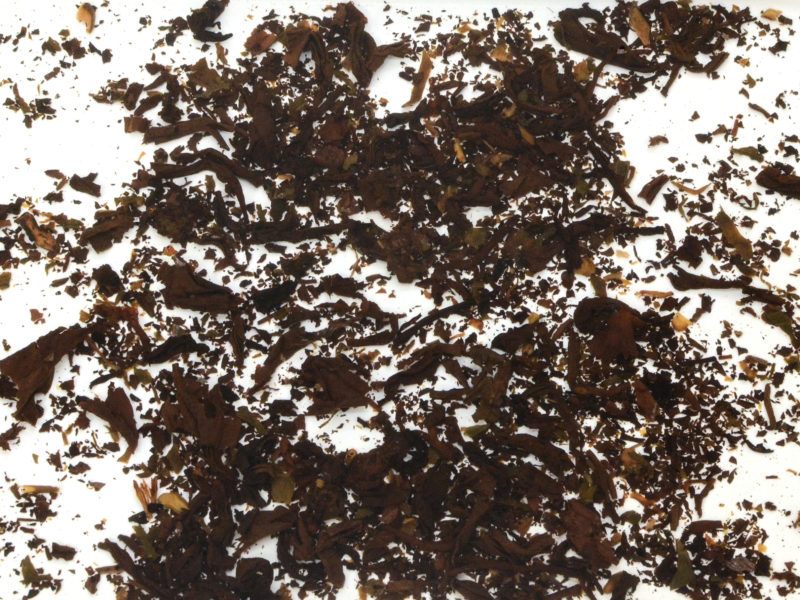 Sticky rice fragrance shu puer wet tea leaves floating in clear water.