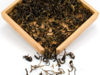 Youle Xiaoshu (Youle Young Tree) black tea dry leaves in a wooden display box.