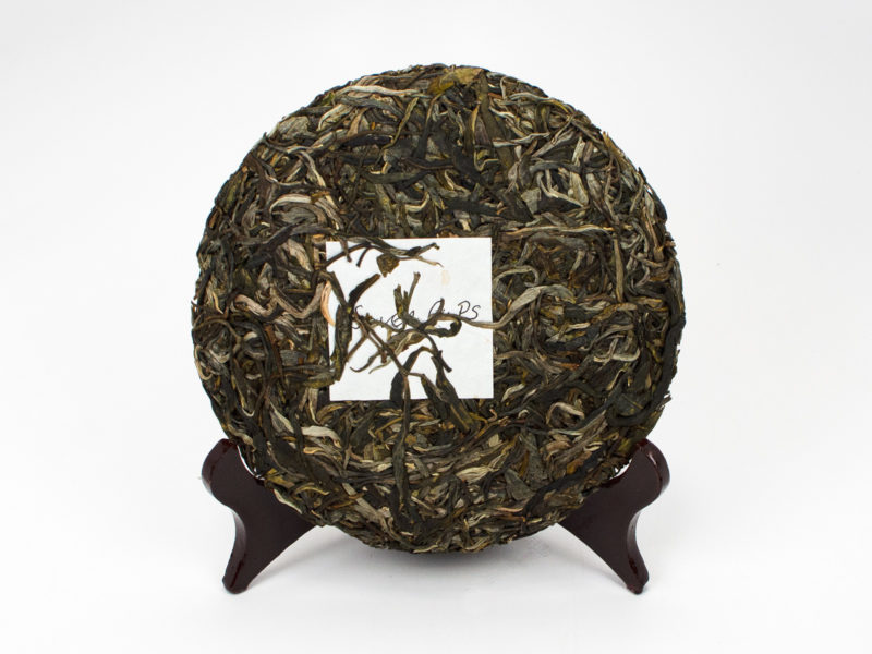 Youle Huangshancha (Youle Forest Tea) sheng puer cake unwrapped.
