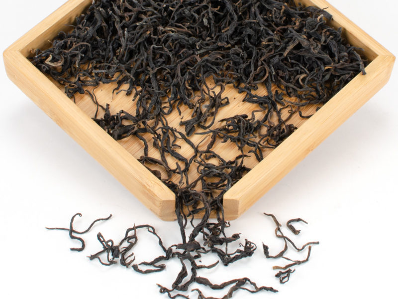 Zijuan Hong (Yunnan Purple Leaf Black) dry black tea leaves in a wooden display box.