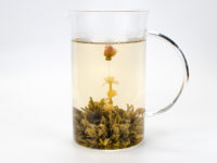 Rose Jasmine blooming tea infused in small glass pitcher