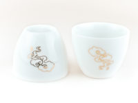 Two Lucky Clouds White Porcelain Teacups, one inverted to show base