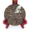 Unwrapped Jingmaishan (Jingmai Mountain) 2007 sheng puer cake in a stand to show off leaves.