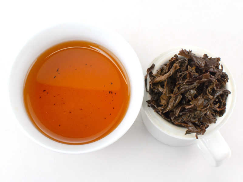 Cupped infusion of Chi Gan (Sweet Vermilion) black tea and strained leaves.