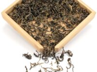 Youle Sun-Dried black tea dry leaves in a wooden display box.