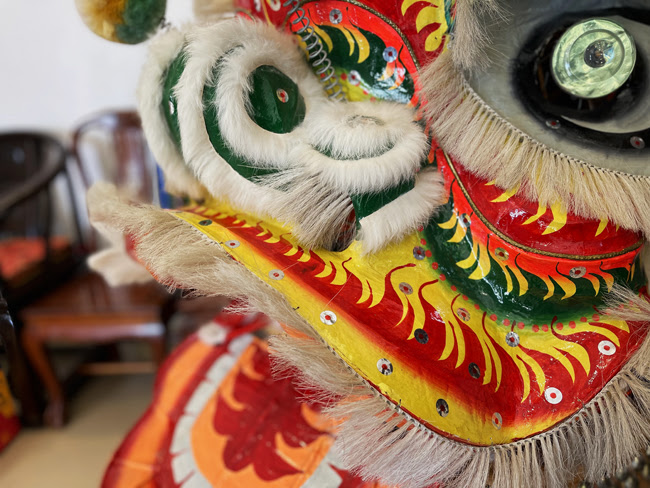 Close-up of the ornate face of a Chinese lion dance lion.