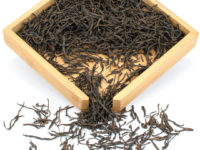 Zhongguo Hong (China Red) black tea dry leaves in a wooden display box.