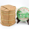 A tong of stacked Jingmaishan (Jingmai Mountain) sheng puer cakes wrapped in bamboo.