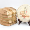 A tong of stacked Cha Tao (Aged Old Tree) shu puer cakes wrapped in bamboo.