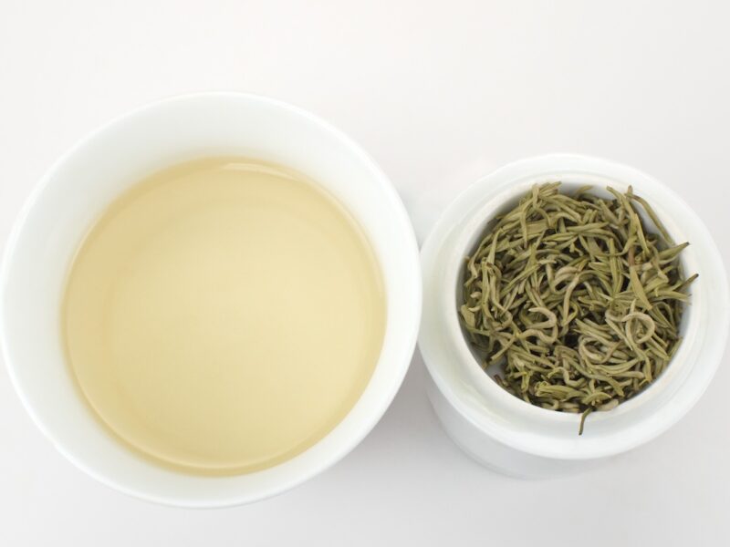Cupped infusion of Zhi Xiang Ganlu (Gardenia Sweet Dew) scented green tea and strained leaves.
